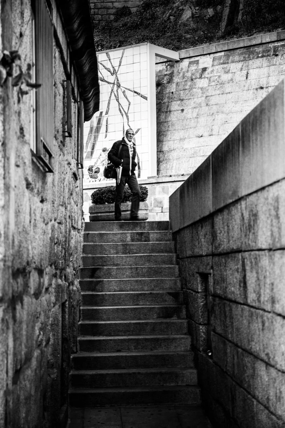 A steep stone staircase in Porto’s Ribeira district, framed by old walls and azulejo tiles