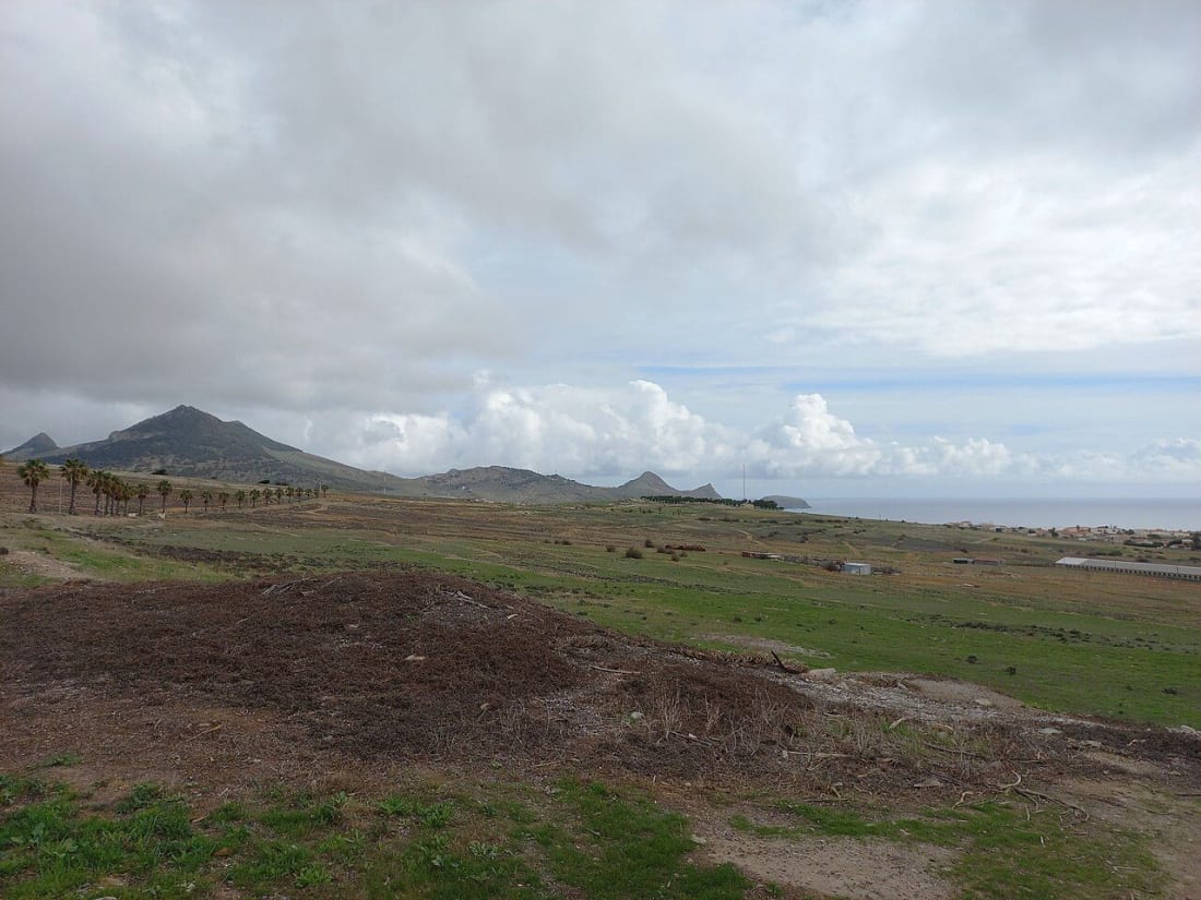 View across the hills and coastline of Porto Santo toward Ilheu de Cima