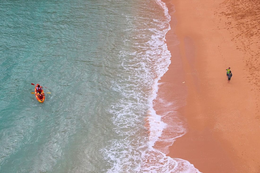 Sea kayakers on the turquoise water off Benagil beach in the Algarve