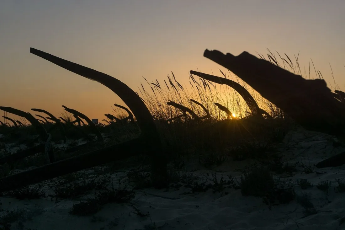 The anchor cemetery in the dunes at Praia do Barril near Tavira at sunset