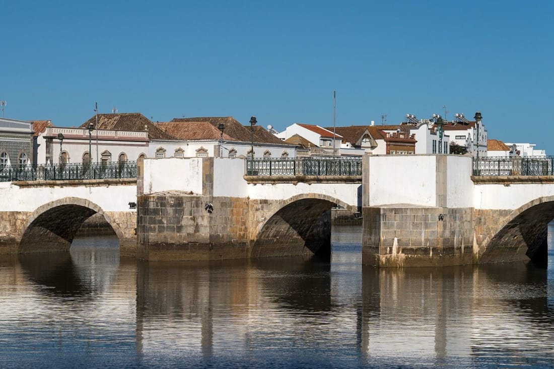 The old bridge over the Gilao river in the quiet town of Tavira