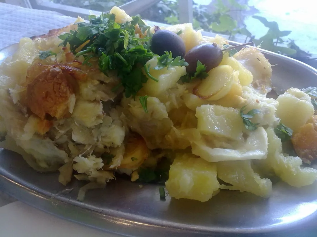 A plate of bacalhau, Portugal's beloved salt cod, served with potatoes, egg and olives