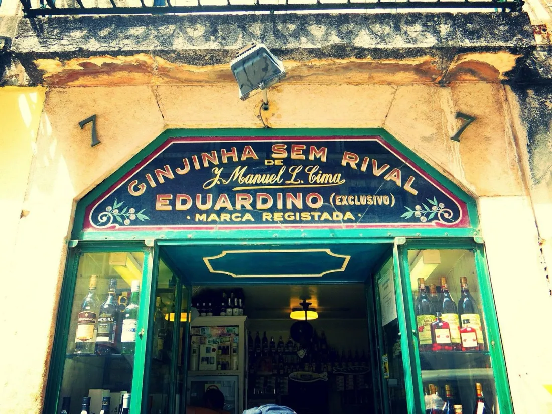 The storefront of a historic ginjinha bar pouring sour-cherry liqueur near Rossio, Lisbon