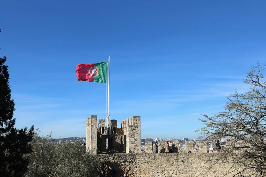 The flag-topped ramparts of São Jorge Castle high above the rooftops of Lisbon