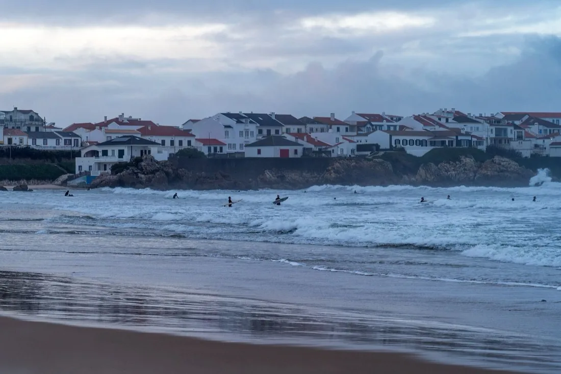 People surfing at Baleal beach on a January day, Peniche