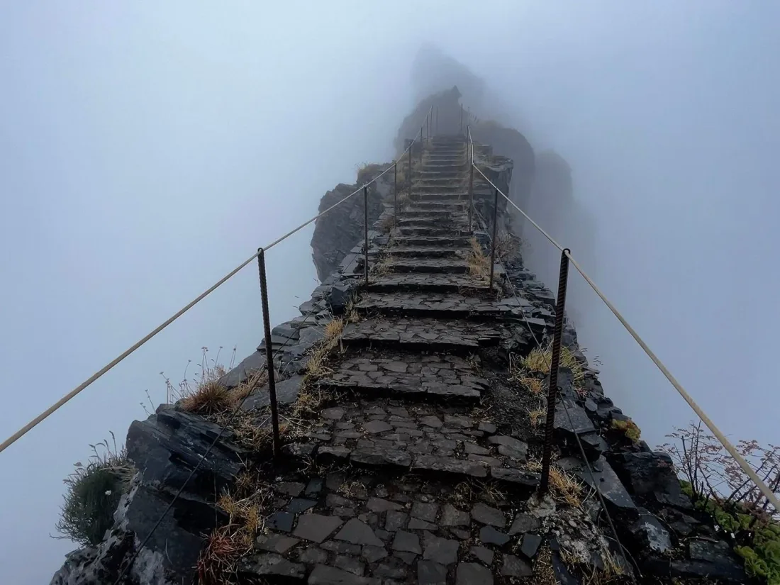 Stone staircase of the PR1 trail cut into the ridge between Pico do Arieiro and Pico Ruivo