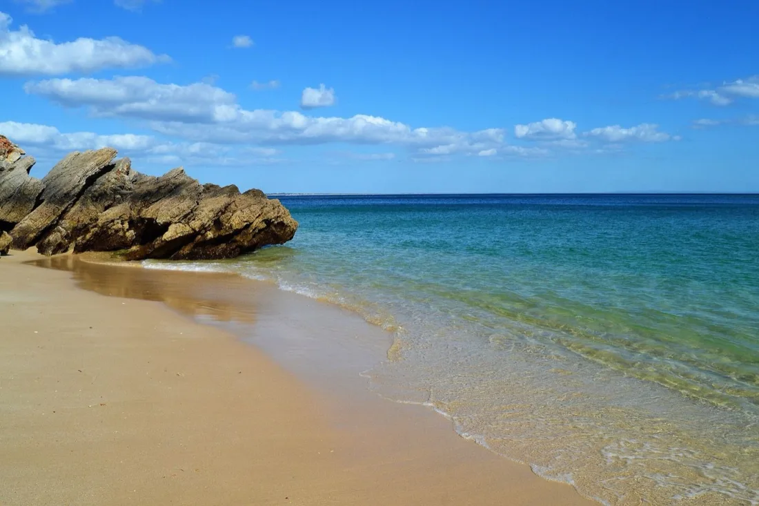 Clear water and tilted rock strata at Praia dos Galapinhos in Arrábida Natural Park