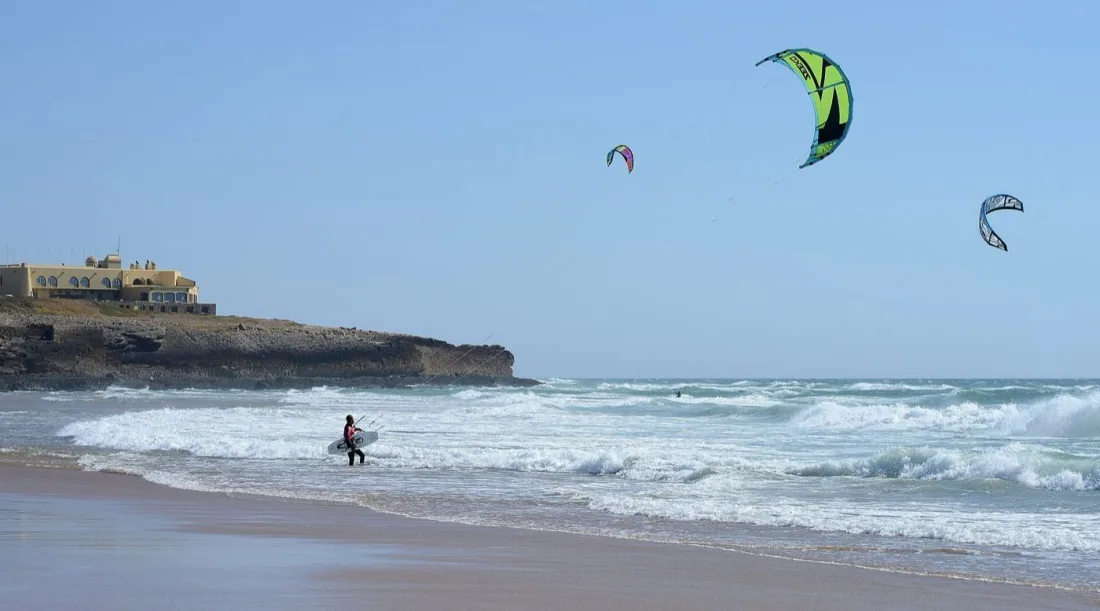 Kitesurfers riding the nortada at Praia do Guincho