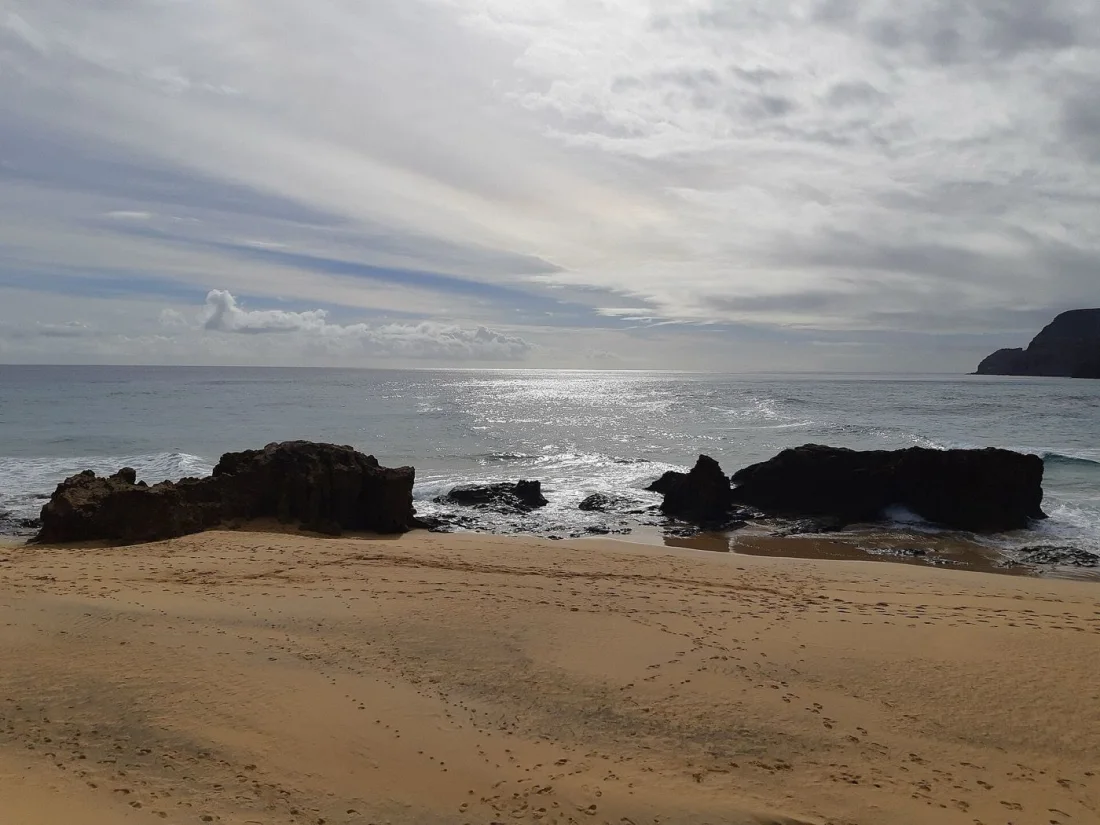 Golden sand and volcanic rocks near Ponta da Calheta on Porto Santo
