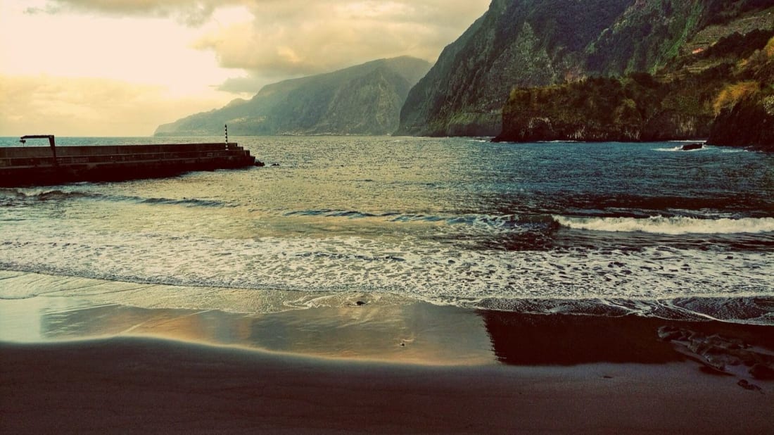 The black sand of Seixal beach under Madeira's green north cliffs