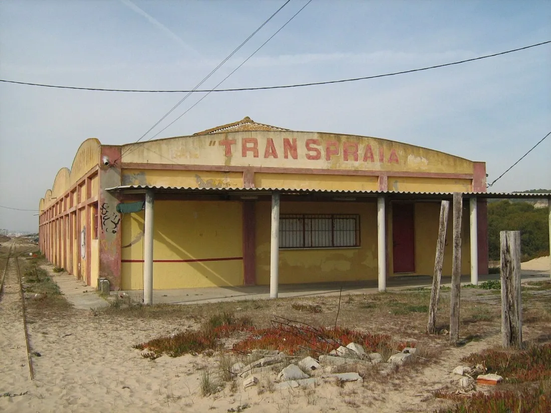 The abandoned Transpraia depot with its faded sign and overgrown track